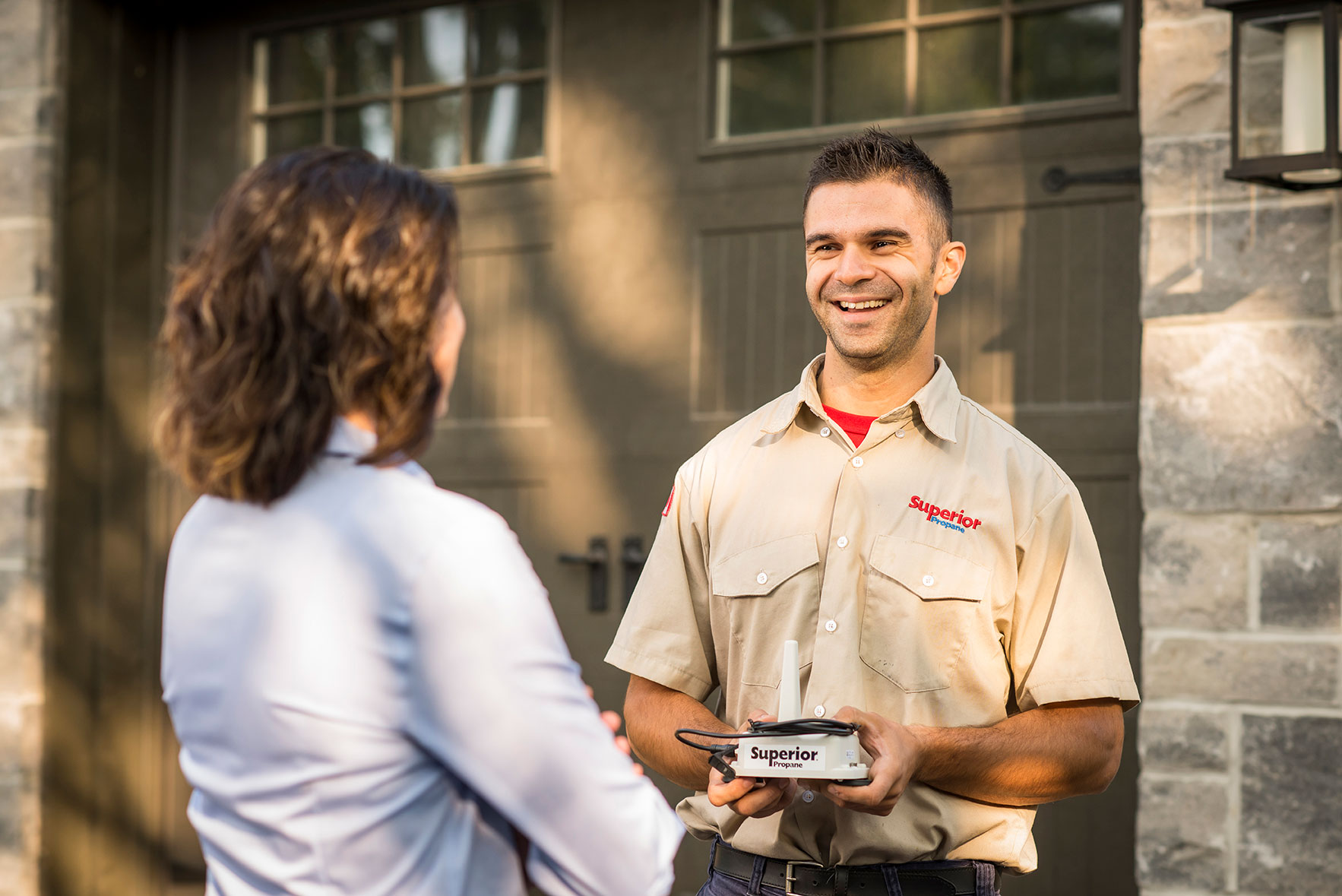 Superior Propane employee talking to a customer about the benefits of switching providers. 