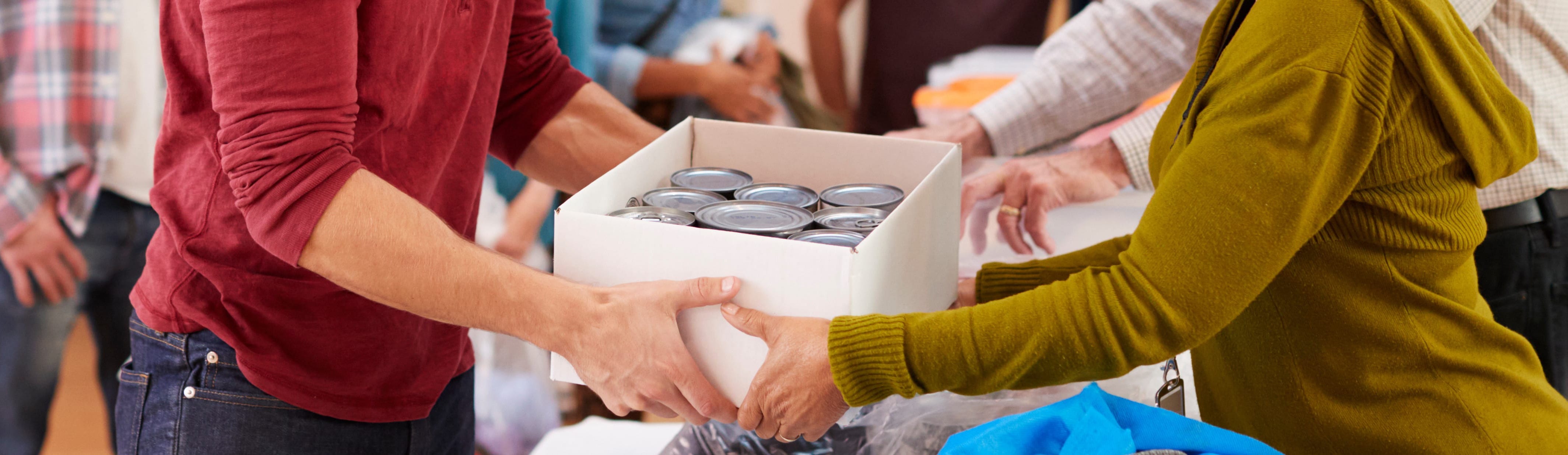 Employees donating food to community charity food bank