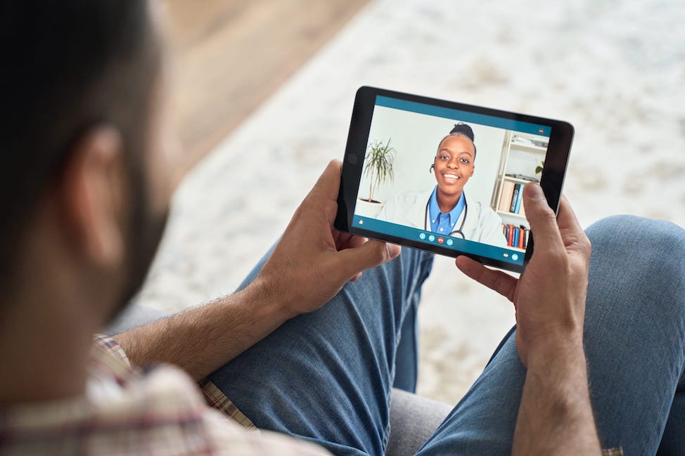 Man having remote videocall with doctor on tablet
