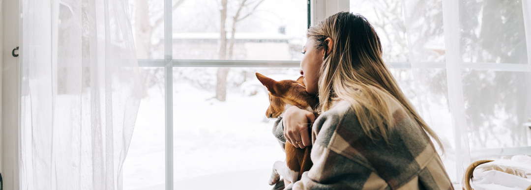 woman looking out the window in the winter