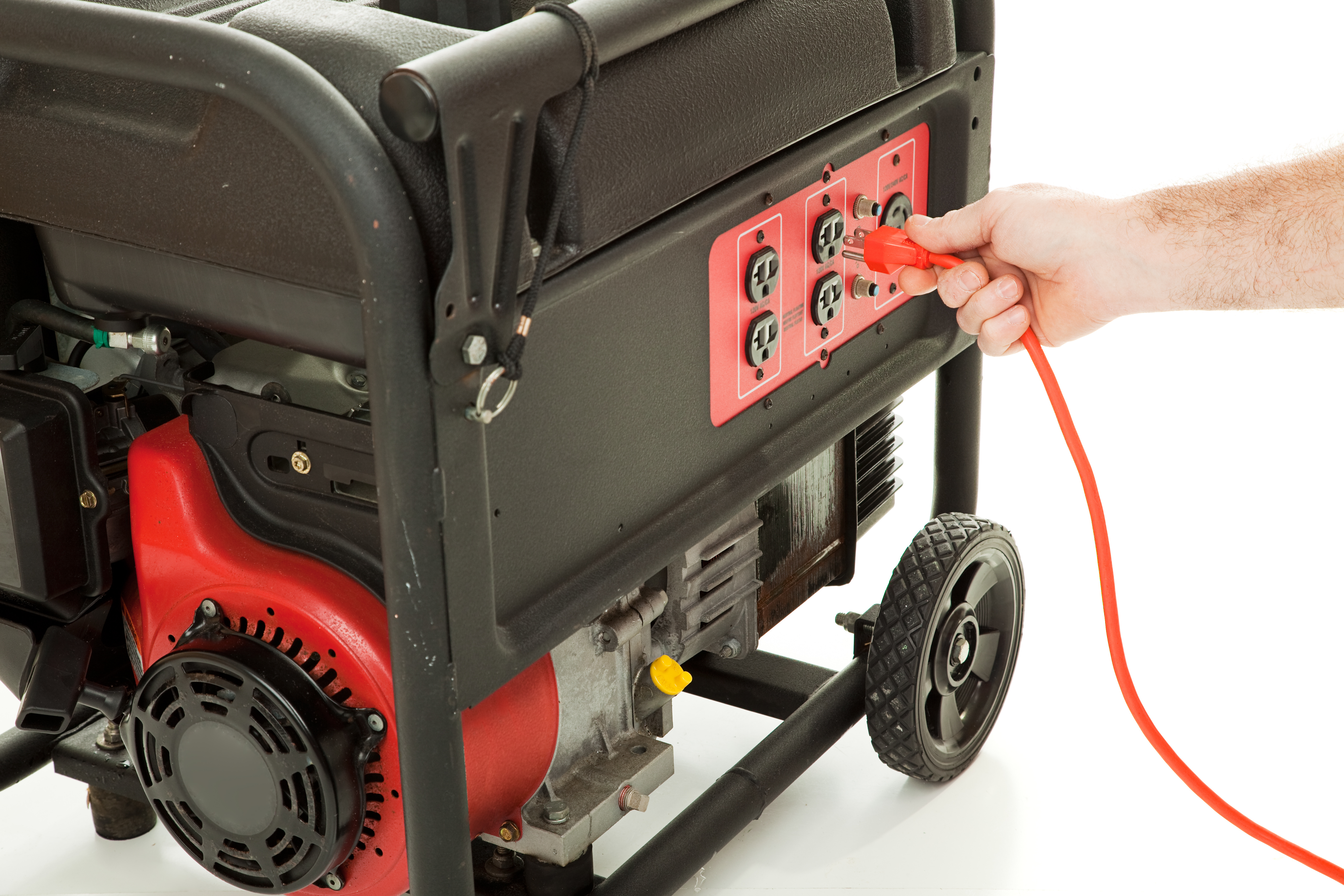 Person placing a plug into a portable propane generator.