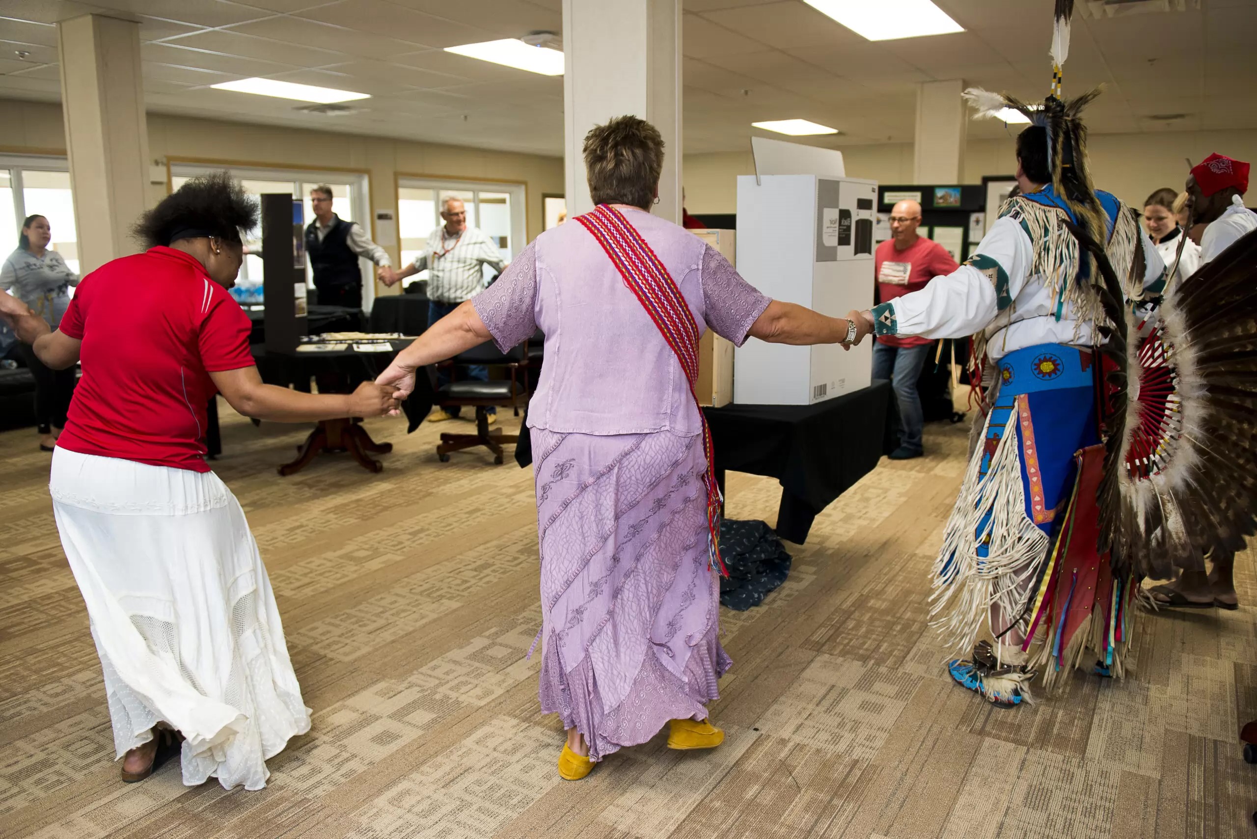 People dancing and holding hands in a circle