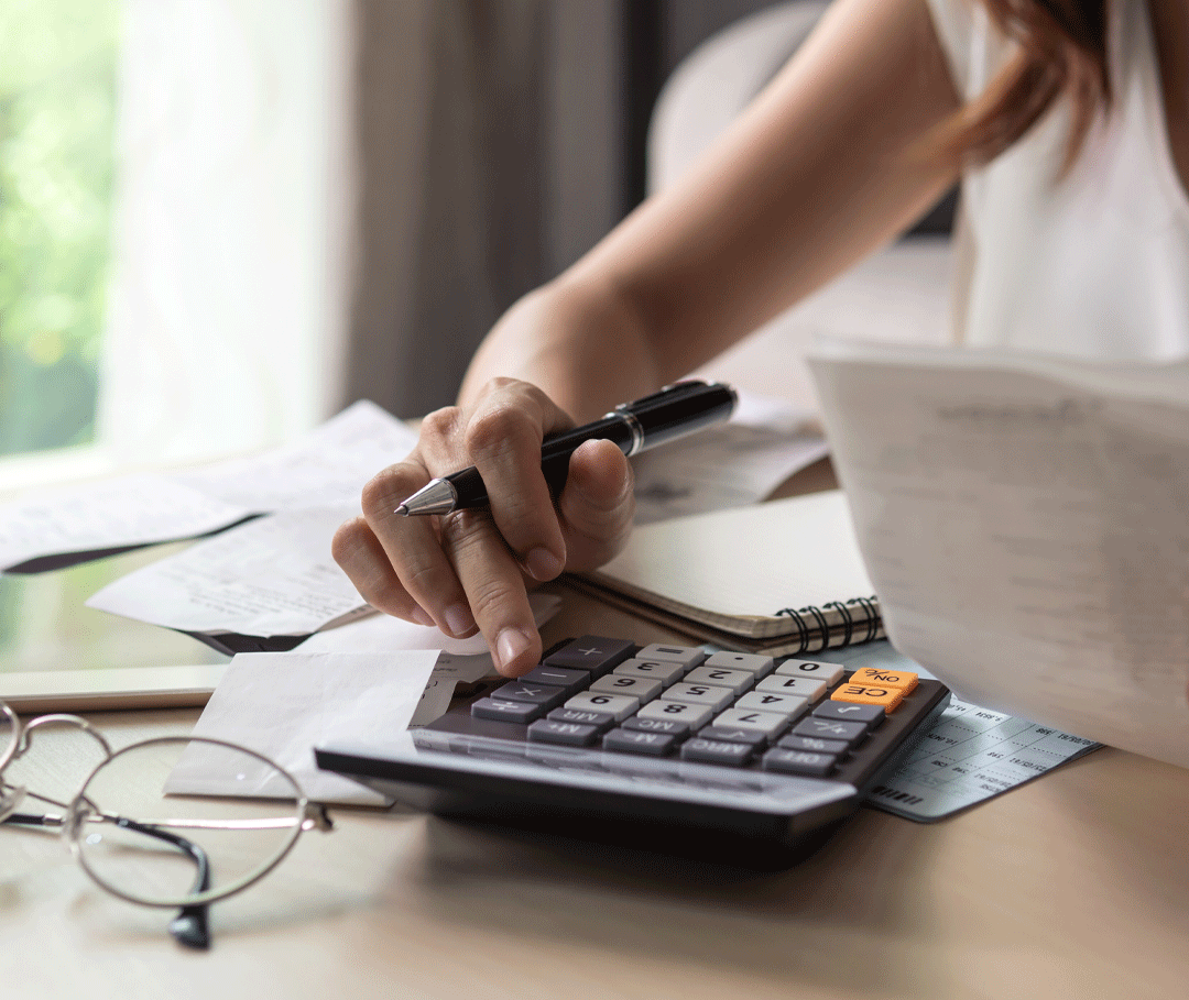 close up of man holding cellphone in front of laptop