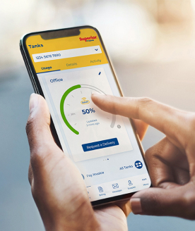 Hands holding mobile phone with the mySUPERIOR app open to check propane tank levels
