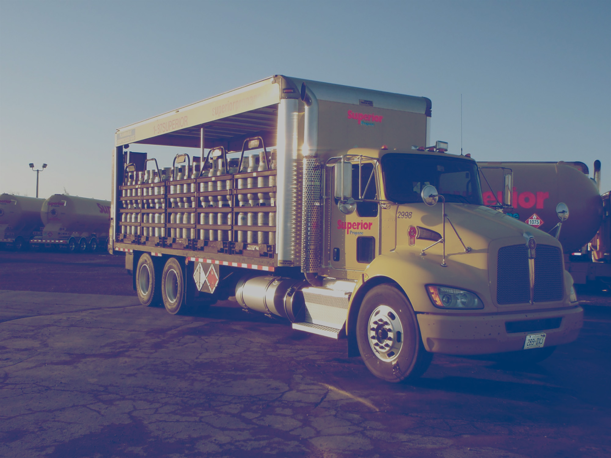 Superior Propane truck that delivers cylinders for forklifts driving out of lot. 