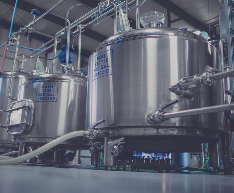 Two large metallic 300 gallon propane heated boil kettles