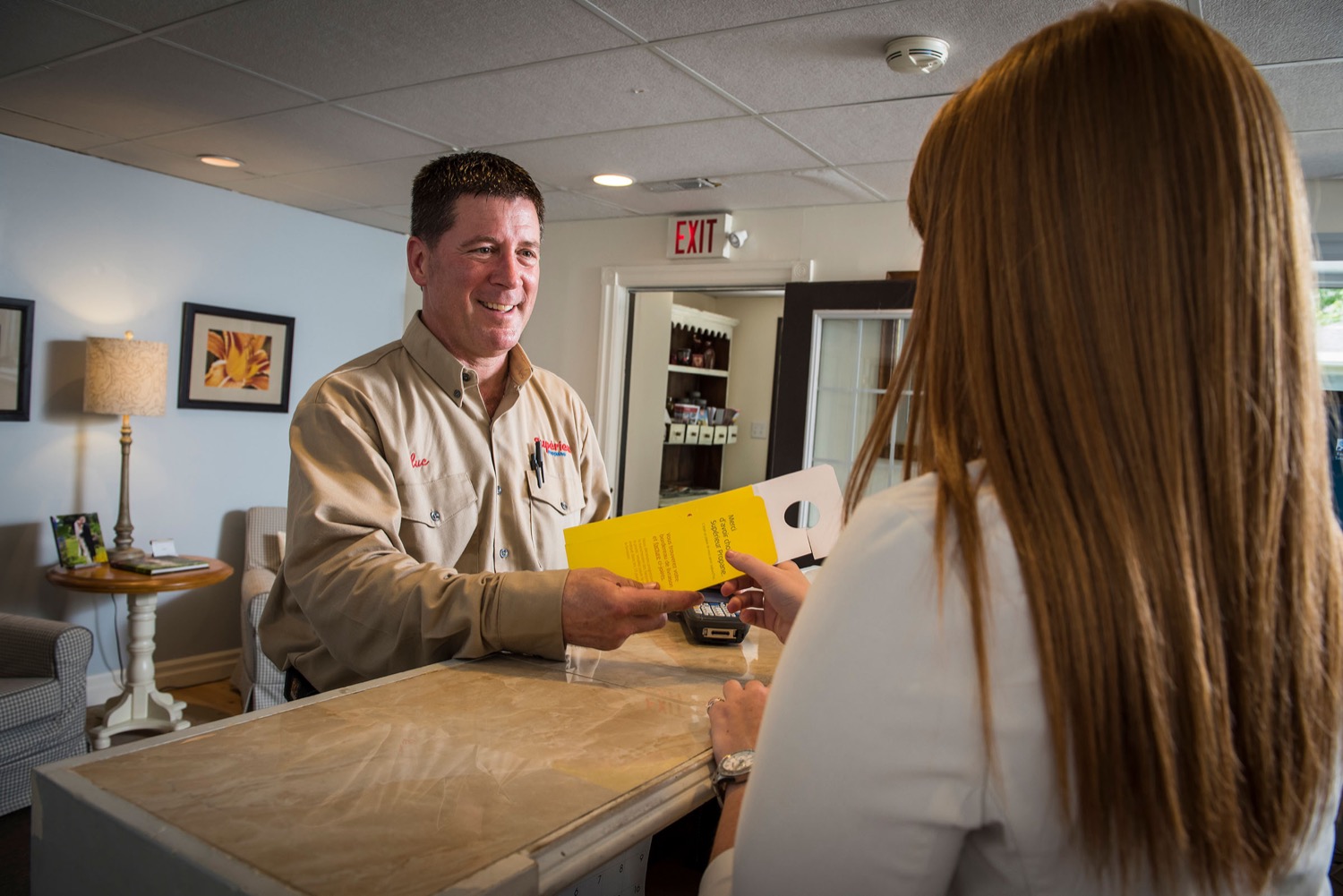 Superior Propane delivery driver providing a delivery notice pamphlet to a new customer. 