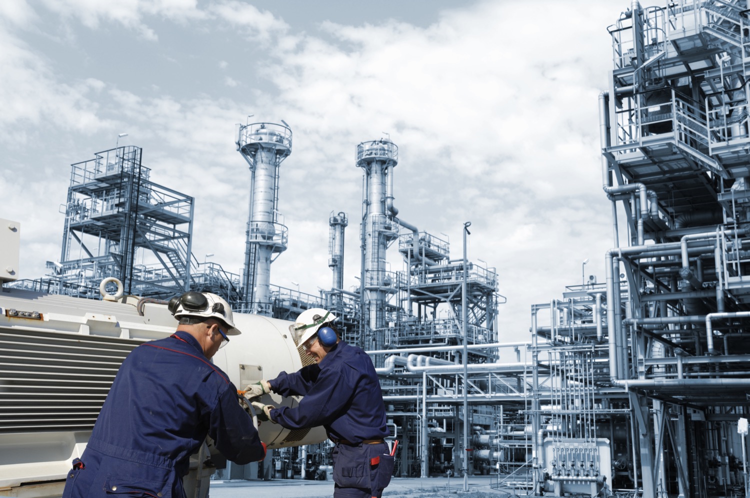 Two of Superior Propane's Certified Partners working on a propane tank outside of a large refinery. 