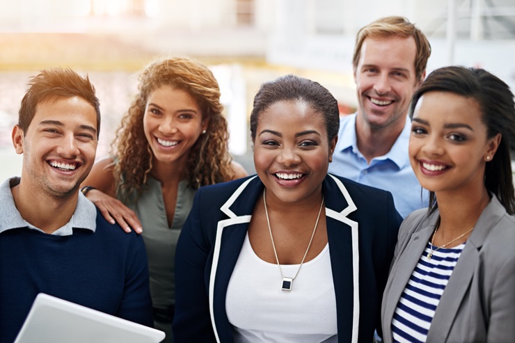 A group of corporate employees smiling.  group of corporate employees