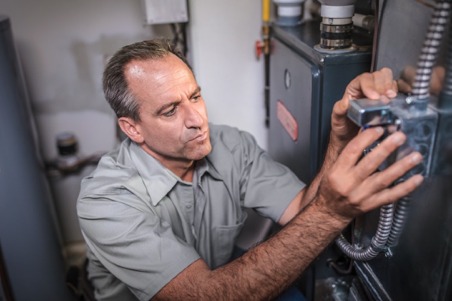 Technician fixing a furnace.