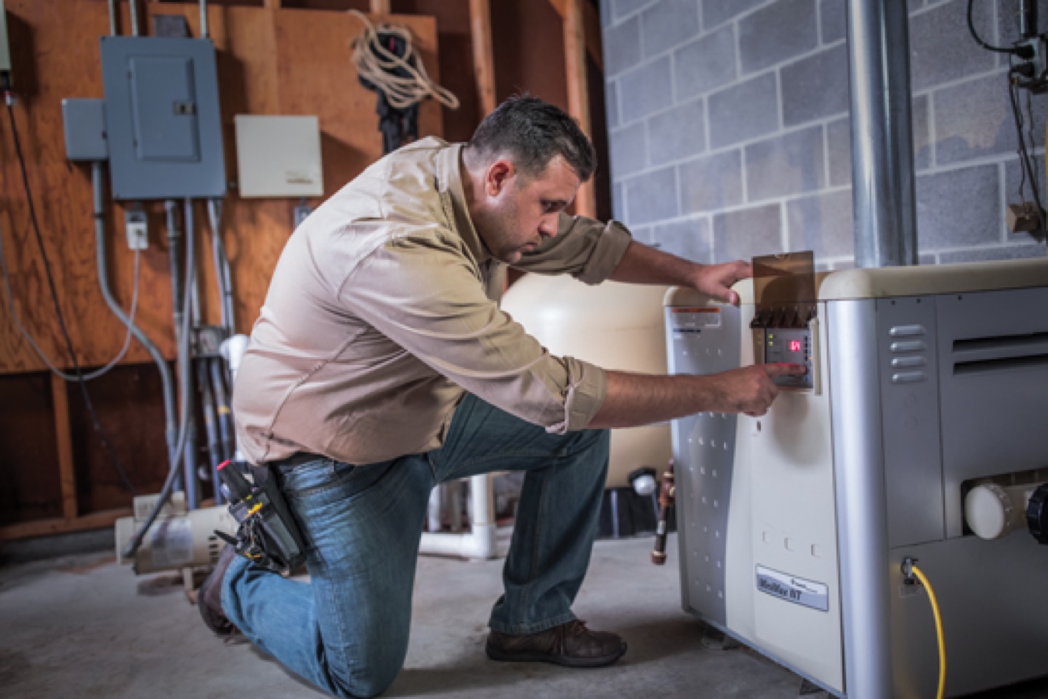 Technician fixing a power generator in a basement. 