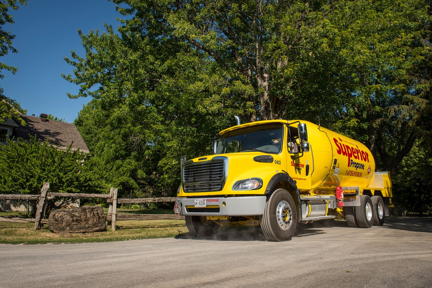 Superior Propane truck driving on a rural road to make a propane delivery.