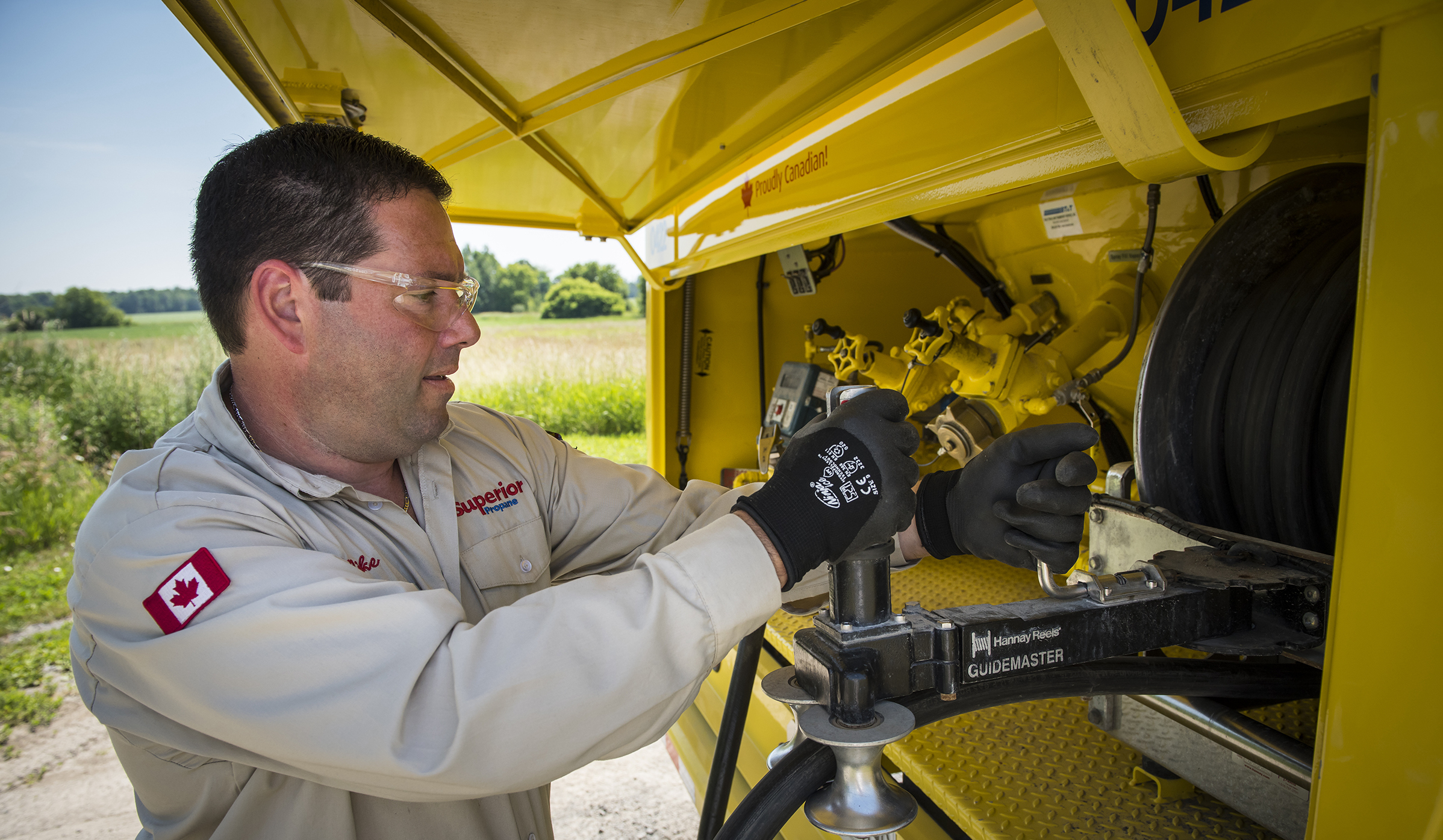 Superior Propane employee safely hooking a fueling line on the back of his truck.