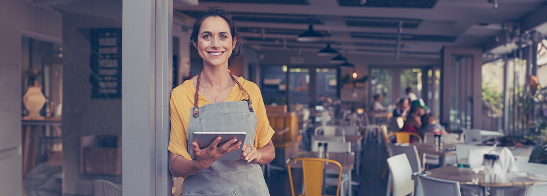 small business owner welcomes customers