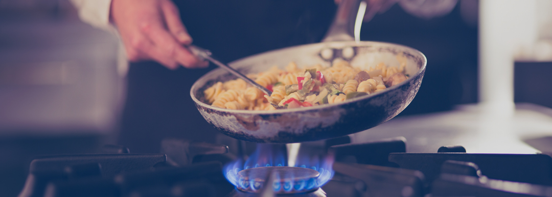 close-up of chef cooking on stove